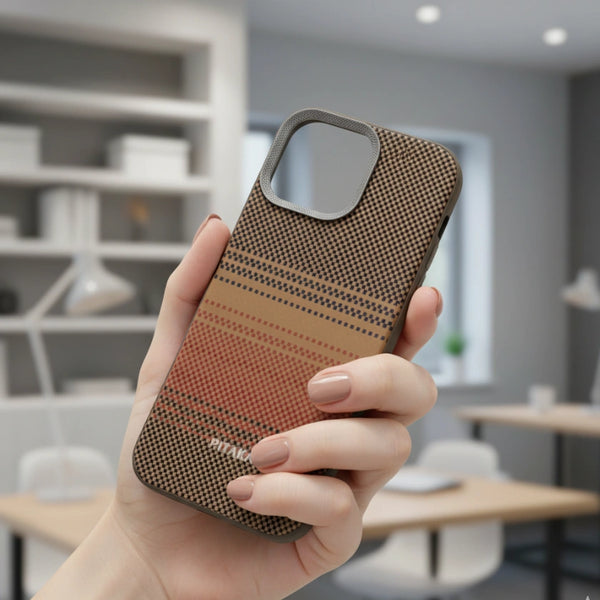 Hand holding a PITAKA Castify iPhone Case with a patterned design in an indoor setting