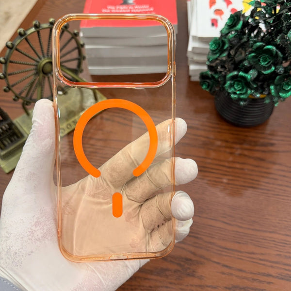 iPhone 17 Pro Max MagSafe Orange Transparent Case held by a gloved hand on a wooden surface.