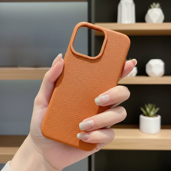 Hand holding a iPhone Lychee-Leather Texture Silicone Case with a blurred indoor background